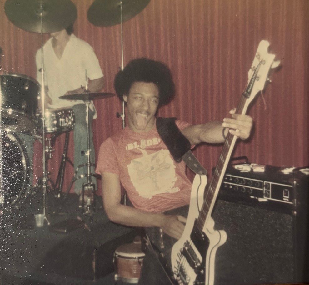 Blade playing bass guitar in a rehearsal room in the 1970s