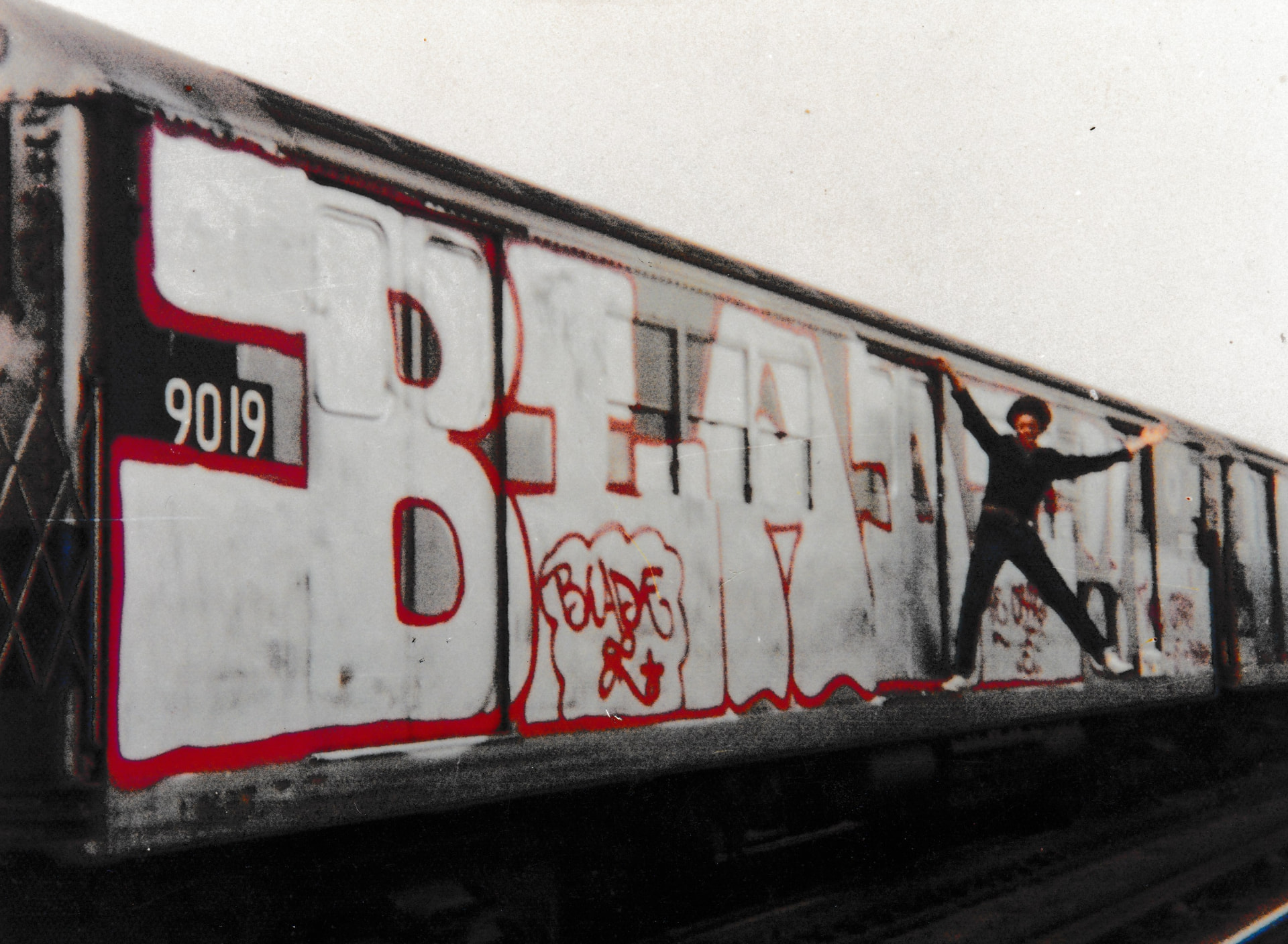 Blade posing on subway car 9019 painted with one of his early whole-car pieces