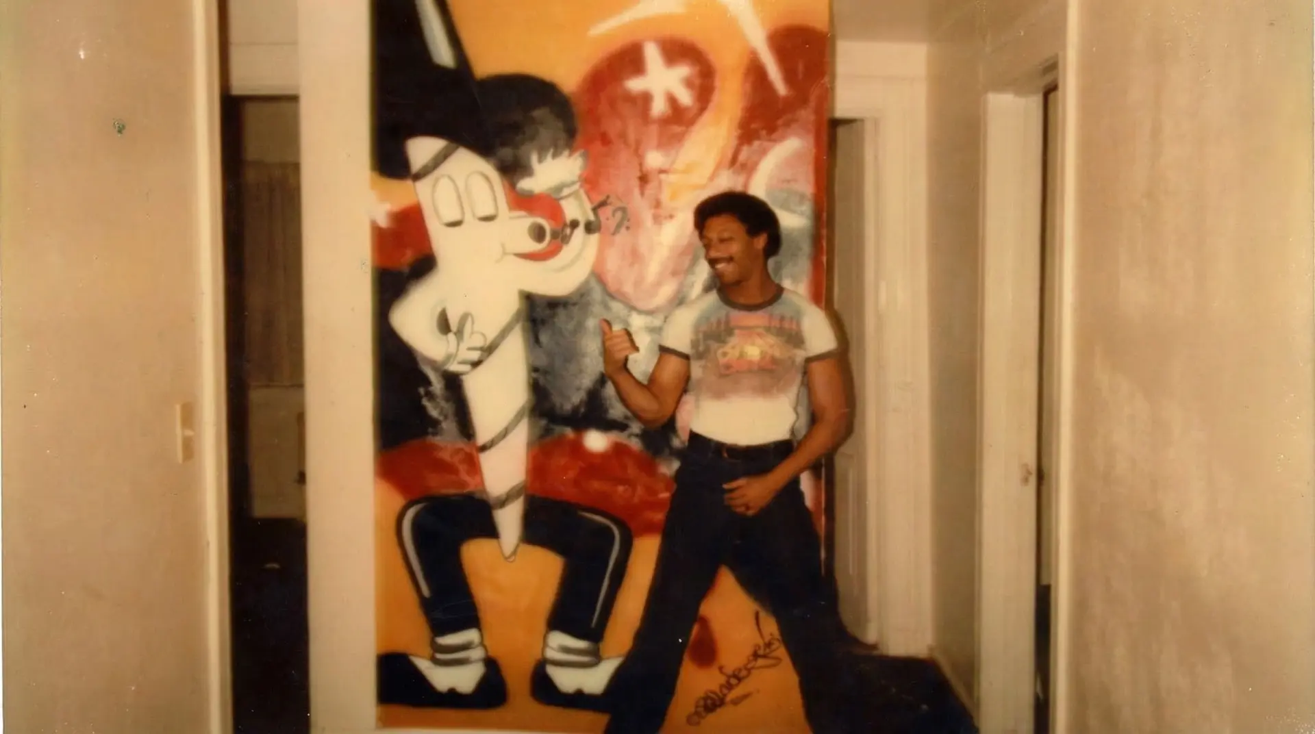 Vintage photo of Blade posing next to his original Jointman painting
