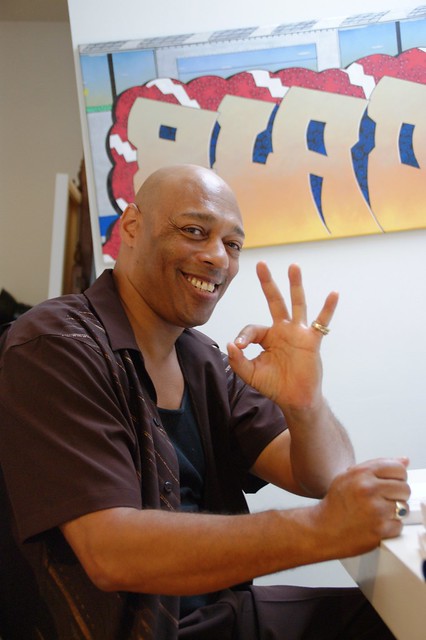 Blade smiling in front of one of his Blade canvases